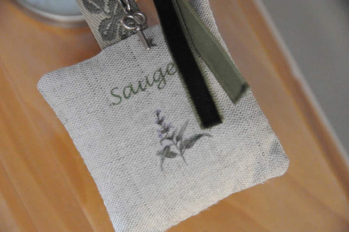 A close-up of a fabric with the word "Sauge" and a floral design.