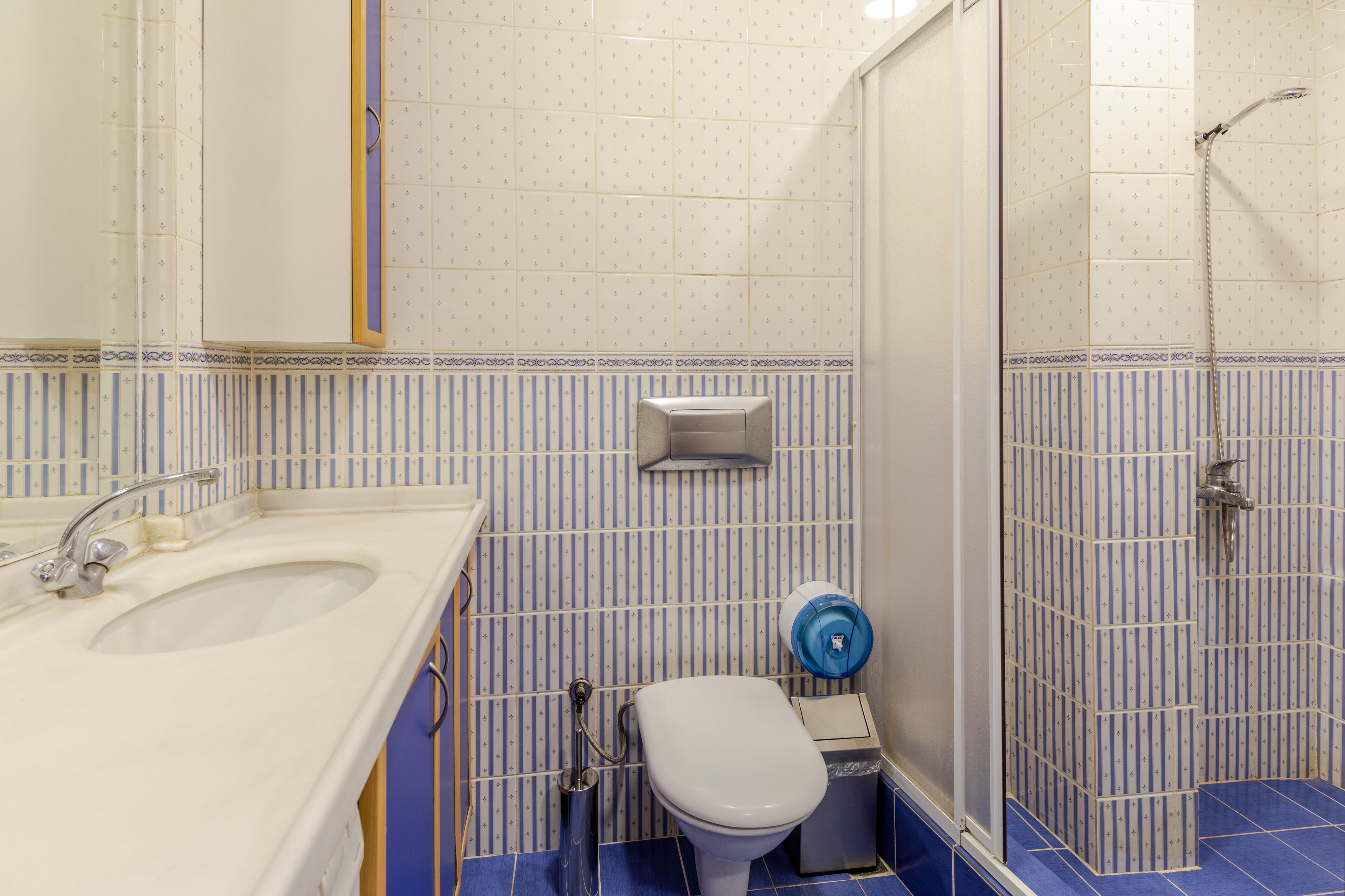 A bathroom with a sink, toilet, and shower.