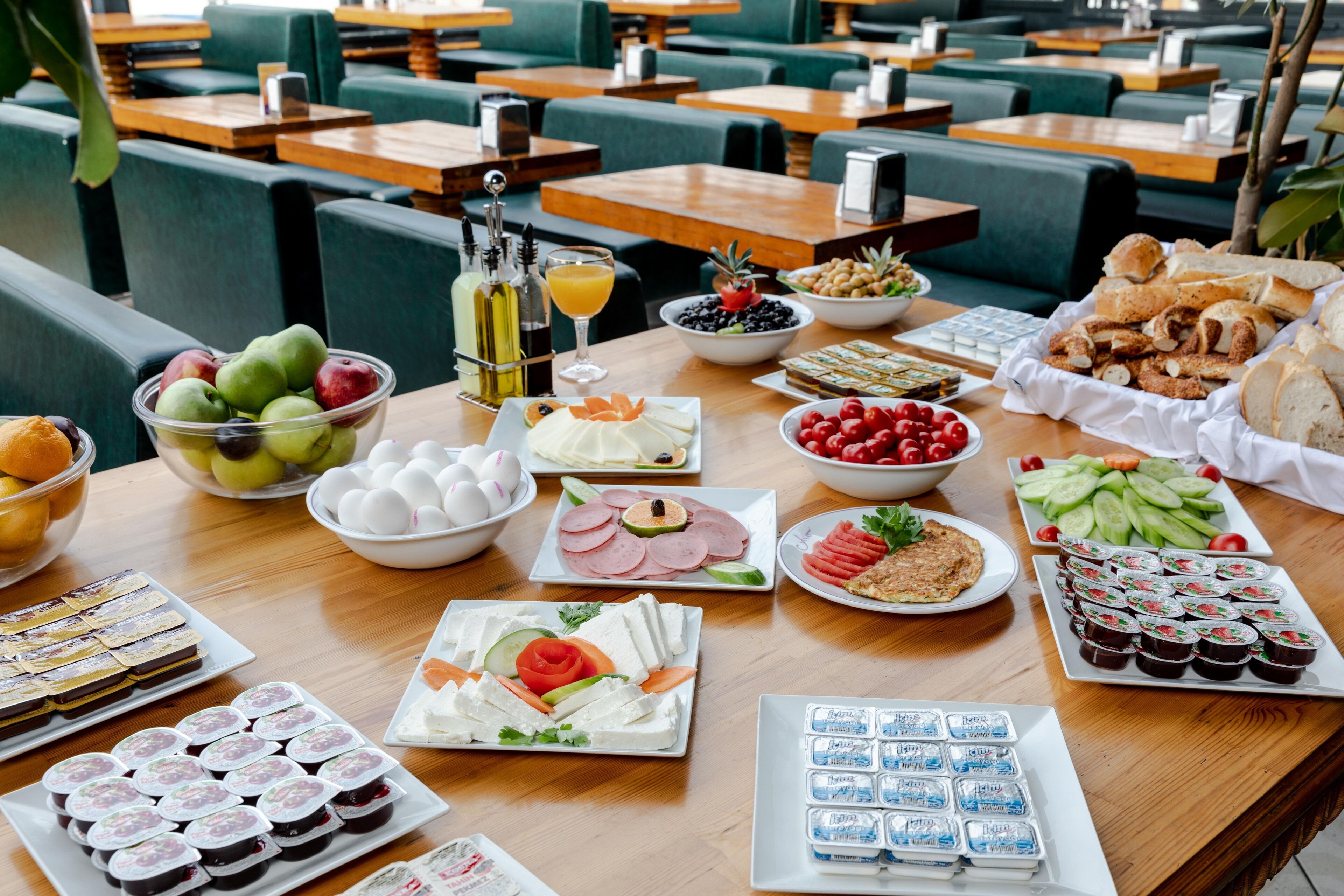 A buffet table with various food items and beverages.