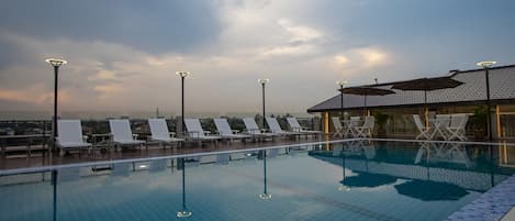 Outdoor pool, open 7:00 AM to 10:00 PM, pool loungers