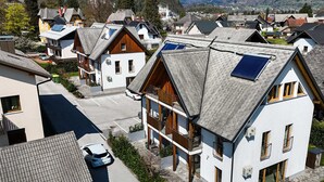 A residential area with modern houses featuring sloped roofs and solar panels.
