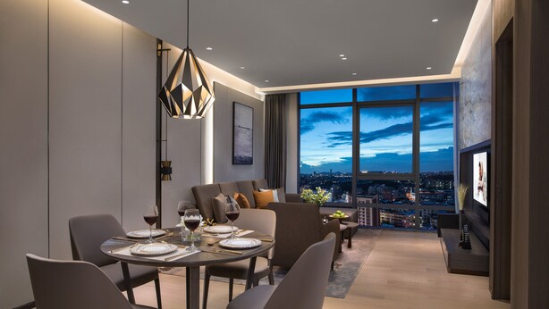 A modern dining area with a city view, a large window, and a contemporary chandelier. - Ascott Songshan Lake Dongguan (Dongguan)