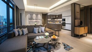 A modern living area with a sofa, coffee table, and a view of the city. - Ascott Songshan Lake Dongguan (Dongguan)