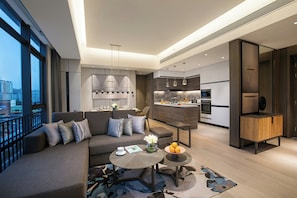 A modern living room with a sofa, coffee table, and a view of the city. - Ascott Songshan Lake Dongguan (Dongguan)