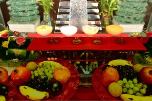 A fruit display with various fruits and a decorative fountain. - Ramada by Wyndham Jaipur Jaisinghpura (Jaipur)