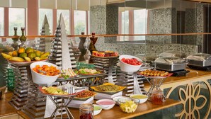 A buffet with various food items and condiments. - Ramada by Wyndham Jaipur Jaisinghpura (Jaipur)
