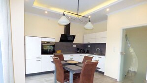 A modern kitchen with a dining area.