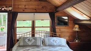 A cozy bedroom with a wooden ceiling, a bed with a quilt, a ceiling fan, and a window with curtains. - Quiet country setting awaits you! (Munnsville)