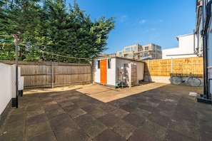 Enjoy an outdoor space with a wooden fence, paved area, and a wooden deck.