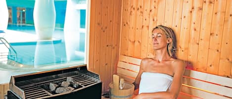 A sauna with a wooden interior, a bench, and a sauna heater.