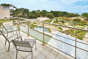 A balcony with a view of a pool and garden area. - Club Les Jardins De L'atlantique (Talmont-Saint-Hilaire)
