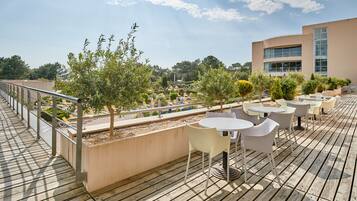 Une terrasse sur le toit, dotée d’un espace extérieur aménagé et offrant une vue sur le paysage environnant.