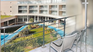 A hotel with a pool, multiple balconies, and a view of the pool area. - Club Les Jardins De L'atlantique (Talmont-Saint-Hilaire)