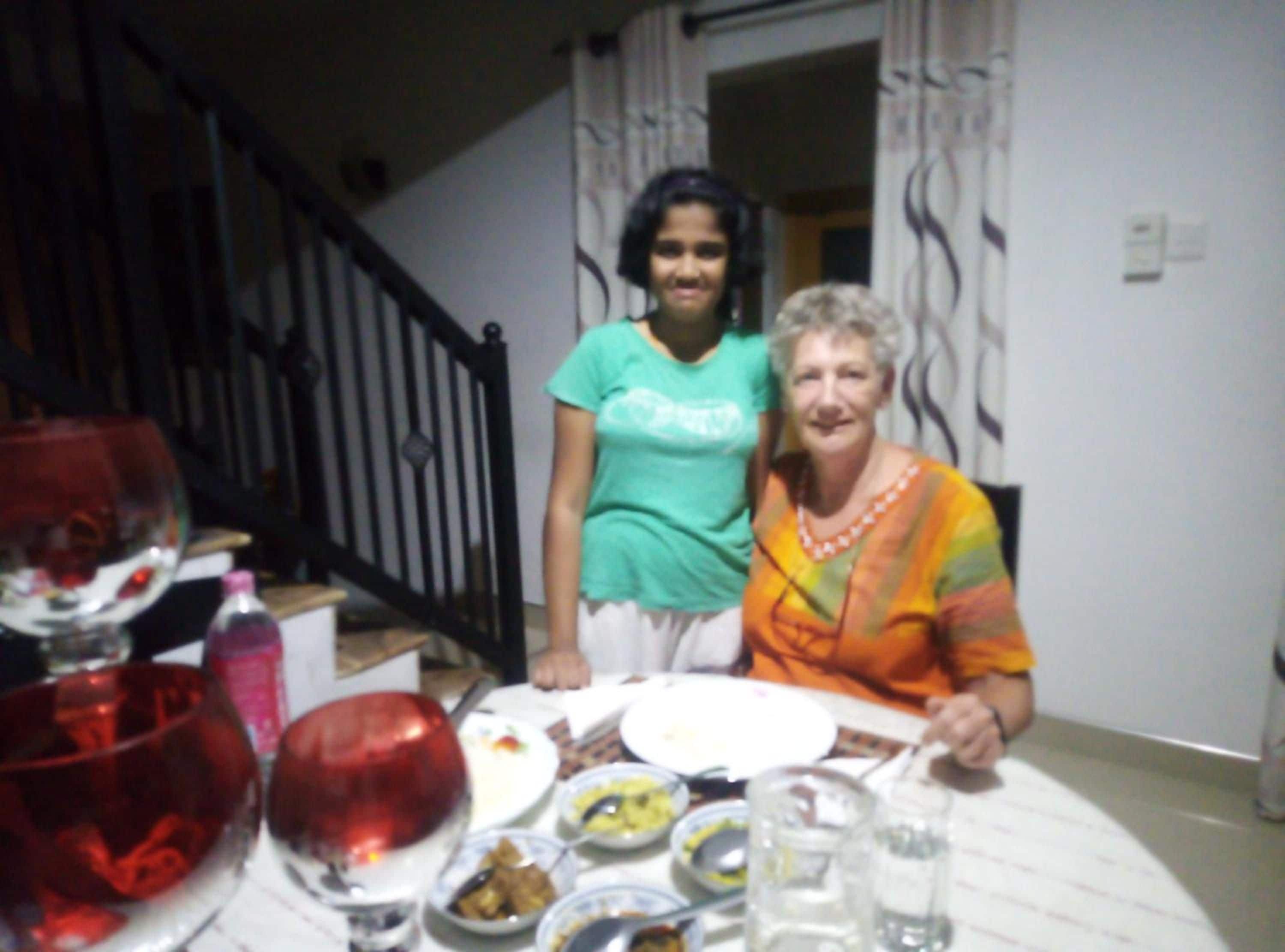 A dining table with various dishes and a glass of water.