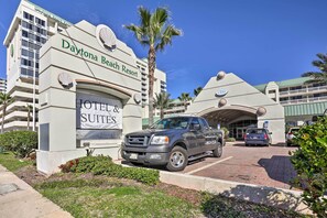 The Daytona Beach Resort Hotel & Suites sign with a parked truck and a car in the driveway. - Daytona Beachfront Condo w/ Ocean View (Daytona Beach)