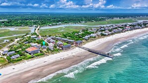 An aerial view of a coastal town with a beach, a pier, and residential buildings. - Oceanfront Ground Level Duplex, Beach Boardwalk, Screened Porch, Dog Friendly (Pawleys Island)