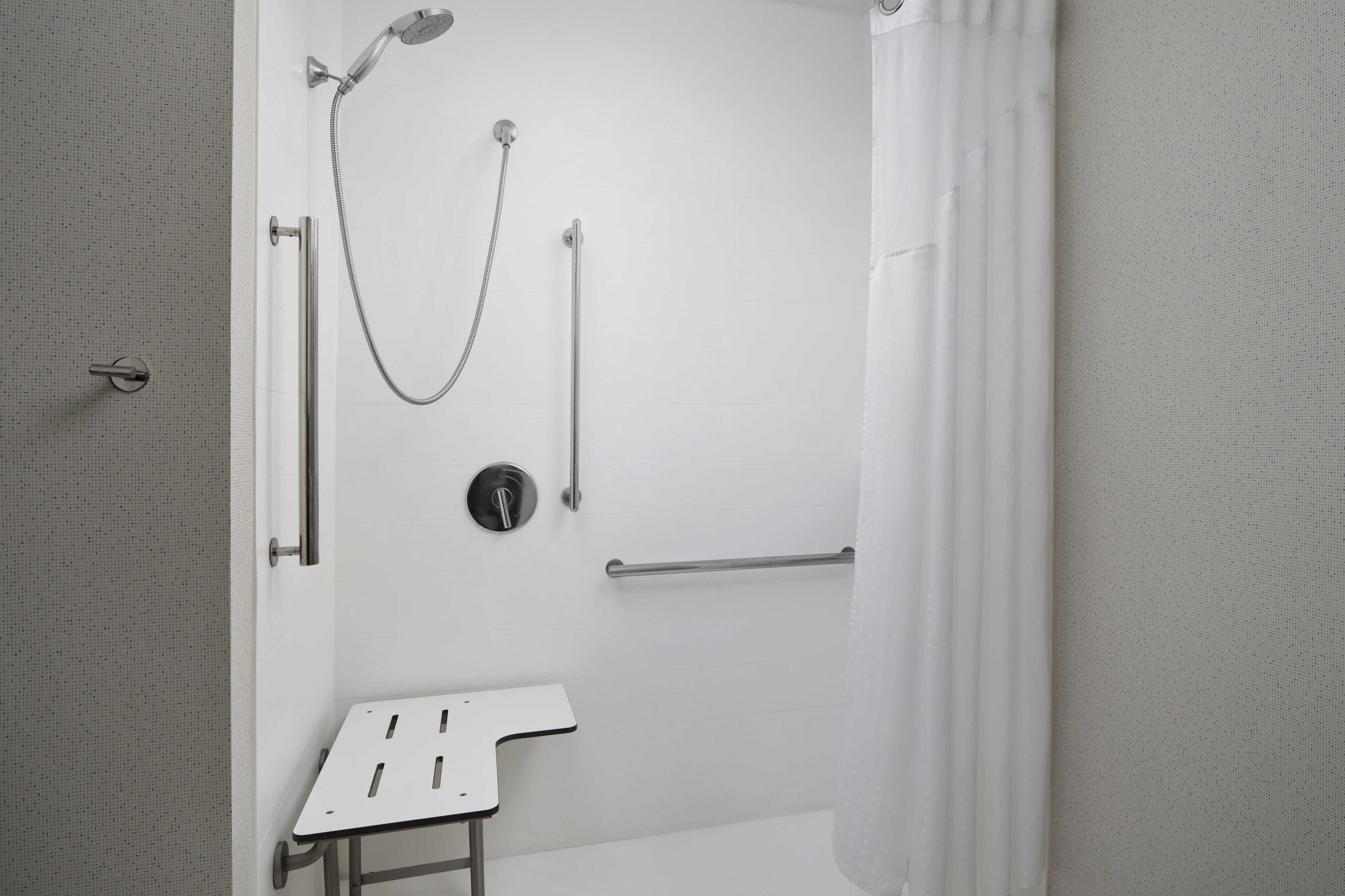 suite, 1 king bed, roll-in shower (mobility accessible) | bathroom | towels