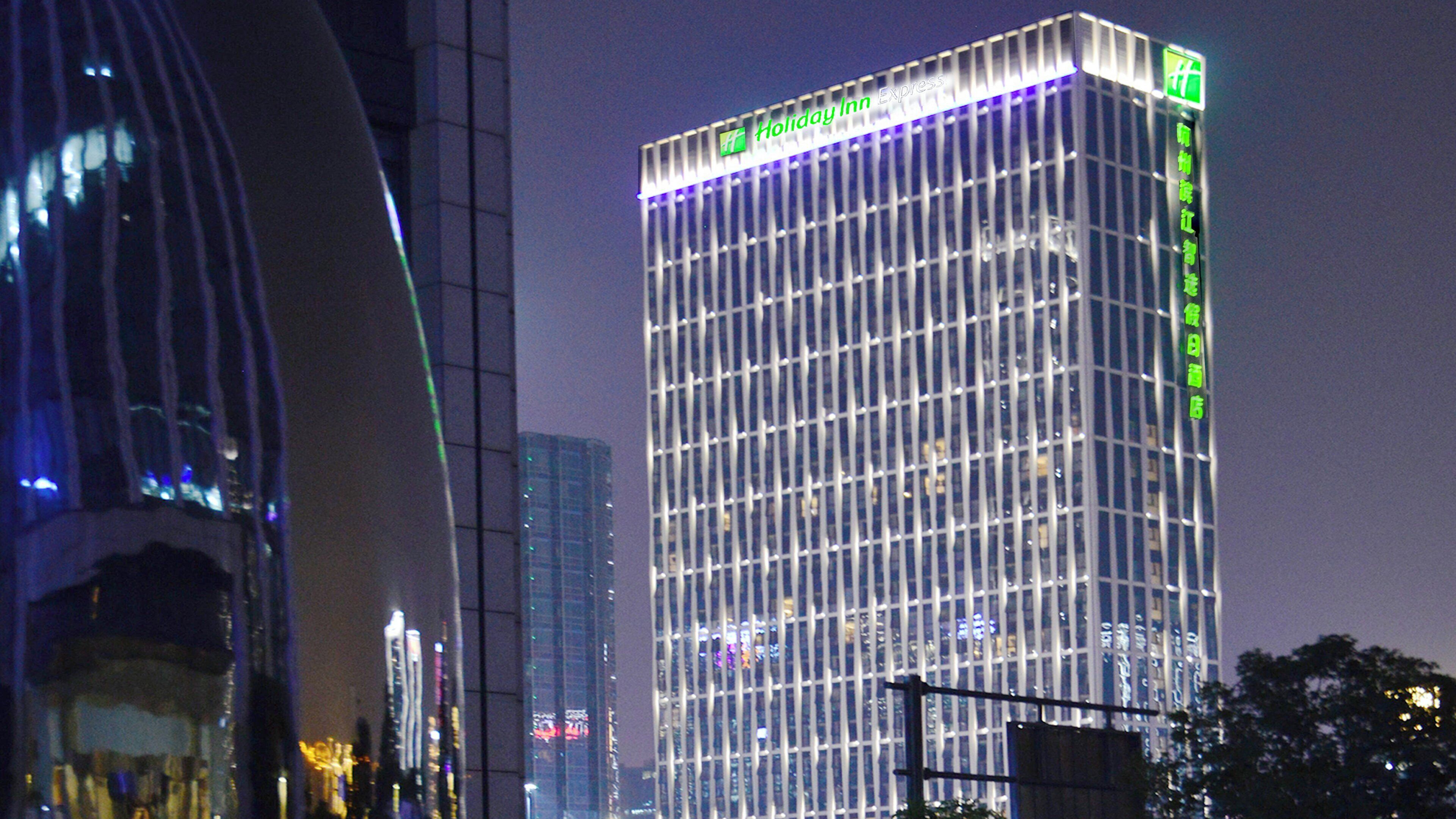 A high-rise building with a prominent 'Holiday Inn Express' sign at the top.