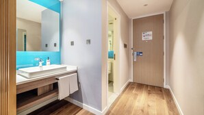 A modern bathroom with a white sink, mirror, and wooden vanity. - Holiday Inn Express Hangzhou Binjiang by IHG (Hangzhou)