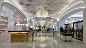A modern lobby with a marble reception desk, a chandelier, and a large mural. - Mercure Taiyuan Jinyang (Taiyuan)