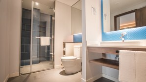 A modern bathroom with a glass shower enclosure, a toilet, and a sink with a mirror above. - Holiday Inn Express Guizhou Qinglong by IHG (Qianxinan Buyei and Miao)