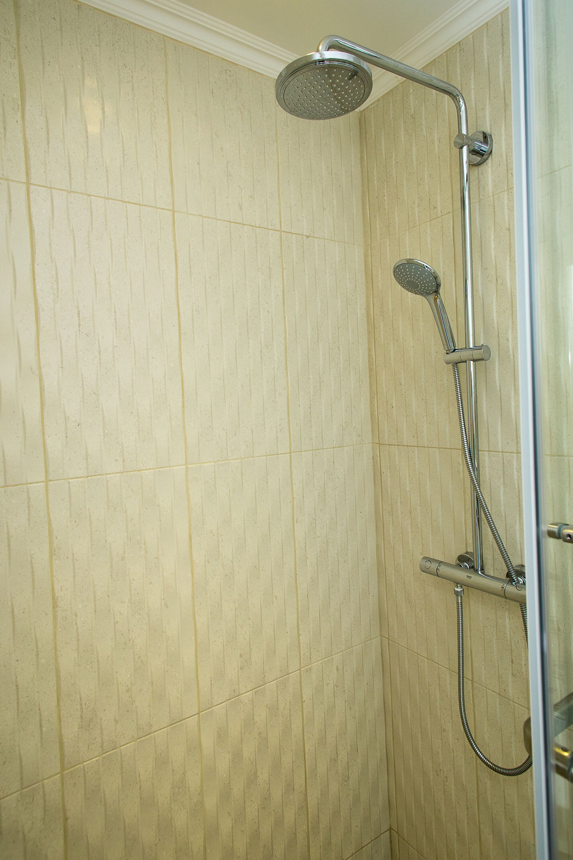 Shower, rainfall showerhead, hair dryer, towels