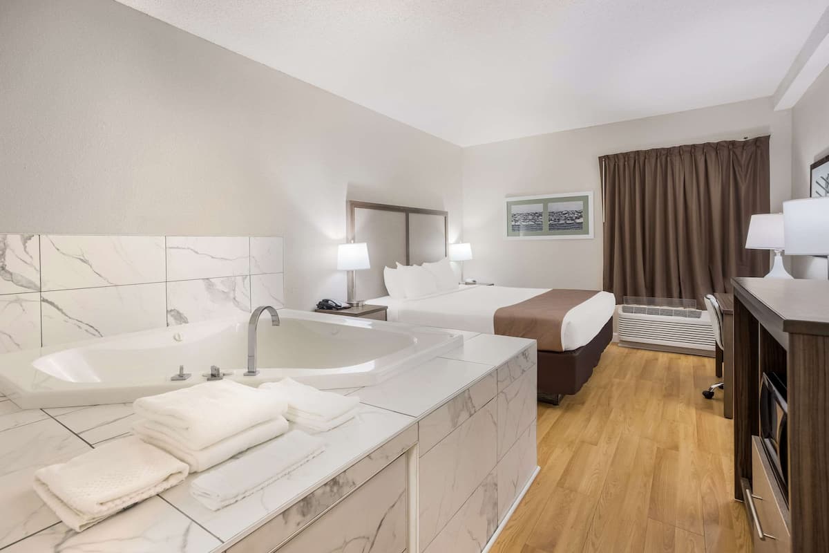 Room, 1 King Bed, Non Smoking, Jetted Tub (Upgrade) | Desk, laptop workspace, blackout drapes, soundproofing