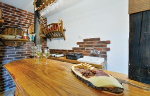 Enjoy a casual meal at this cozy dining area with a wooden table and comfortable seating.