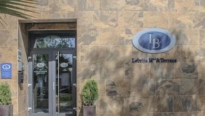 The entrance to Lebrija Hotel & Spa with a stone facade and a glass door. - Hotel LB Lebrija by MA 22 Puntos (Lebrija)