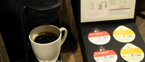 A coffee machine dispensing coffee into a cup, with a menu displaying coffee options.