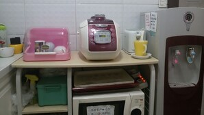 A kitchenette with a microwave, a rice cooker, a coffee maker, and a water dispenser. - Jukjeon Guesthouse iwantlivingtel (Yongin)