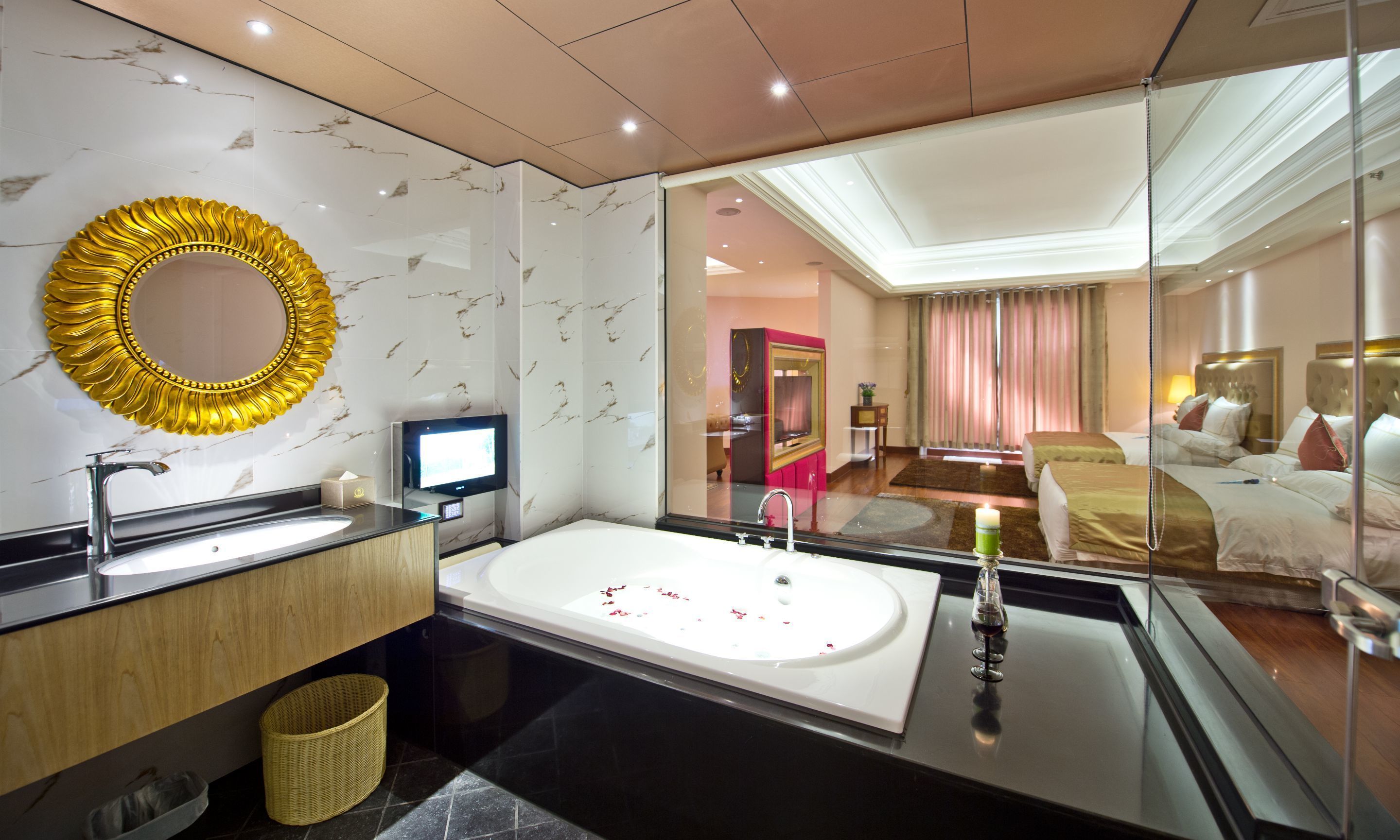 A modern bathroom with a large mirror, a bathtub, and a vanity with a sink.