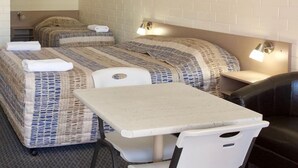 A compact room with two beds, a small table, and two chairs. - Pioneer Motel (Goondiwindi)
