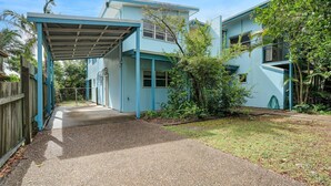 A two-story house with a covered driveway and a small garden. - COOLAMAINE 1 - Rainbow Beach. Easy walk to beach and shops. (RAINBOW BEACH)