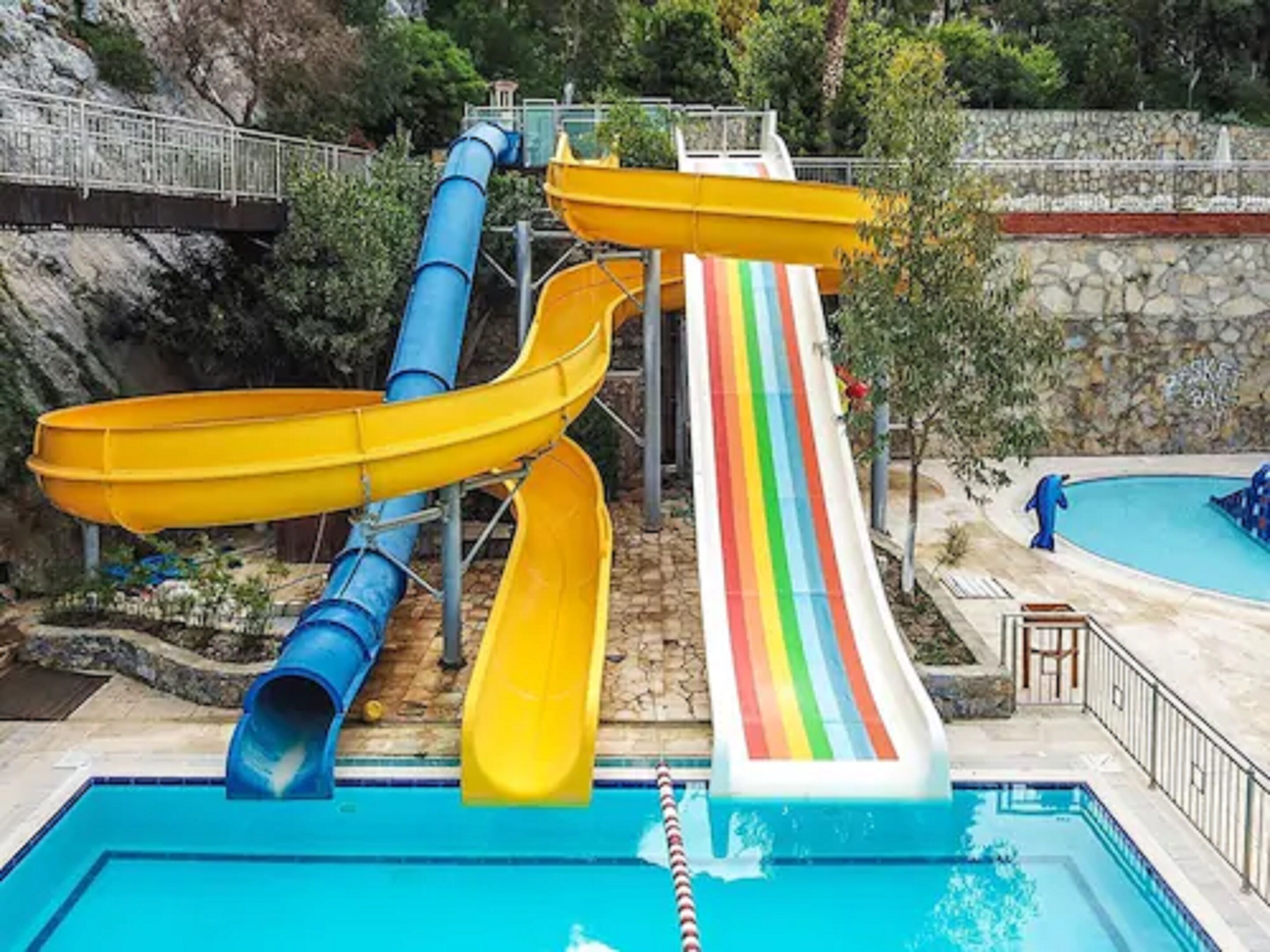 A water park with multiple slides and a pool.