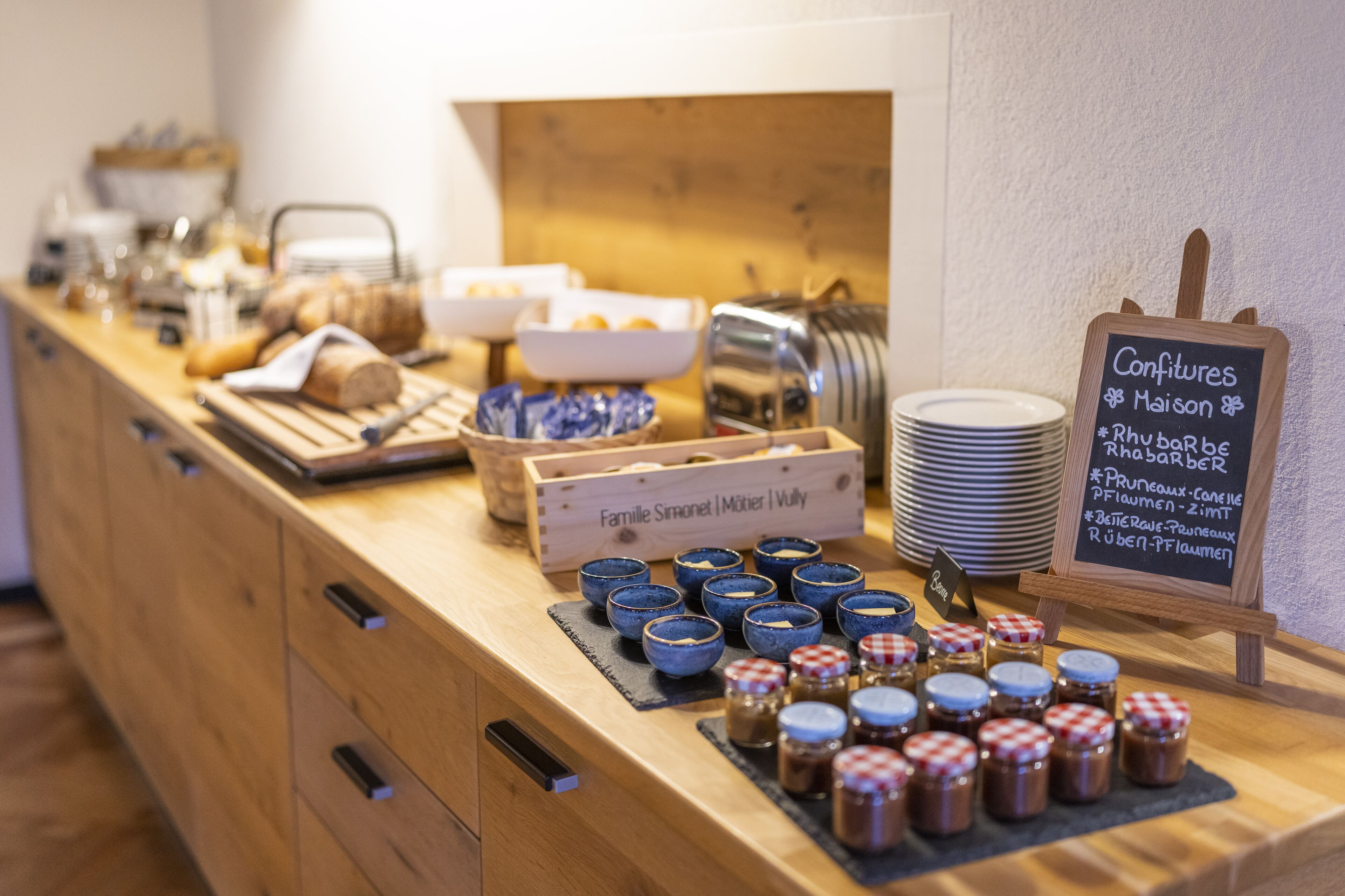 A buffet counter with various food items and condiments.