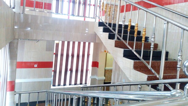 A multi-level interior with a metal staircase featuring ornate balusters and a handrail. - Denposon Royal Hotel (Lagos)