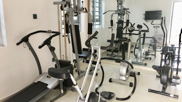 A gym with various exercise equipment including treadmills, stationary bikes, and weight machines. - Sky Rock Hotels (Lagos)