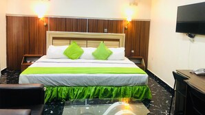 A hotel room with a bed, a TV, a desk, and a chair. - Sky Rock Hotels (Lagos)