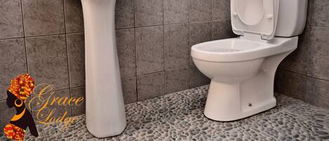 A bathroom with a pedestal sink and a toilet.