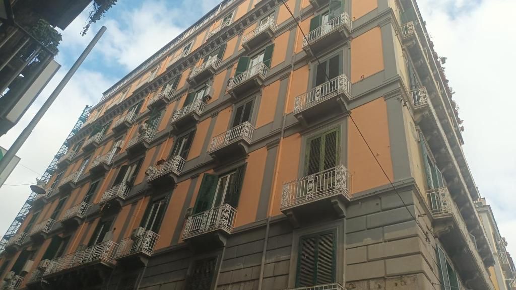 A multi-story building with balconies and windows.