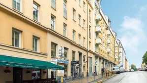 A row of yellow buildings with storefronts, including a bakery and a restaurant. - Stockholm Smart Stay (Stockholm)
