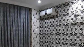 A neatly made bed with white linens, a headboard, and a window with curtains. - Bakuvi Tourist Apartment B022 (Baku)
