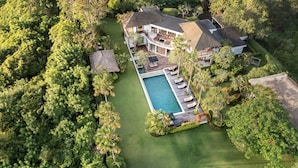An aerial view of a large house with a swimming pool, surrounded by lush greenery. - Villa Uma Nina by Nakula (Nusa Dua)