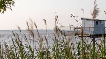 A small wooden structure by a body of water, possibly a dock or pier, with a crane and a sign that reads "MARTIN PA 22840".