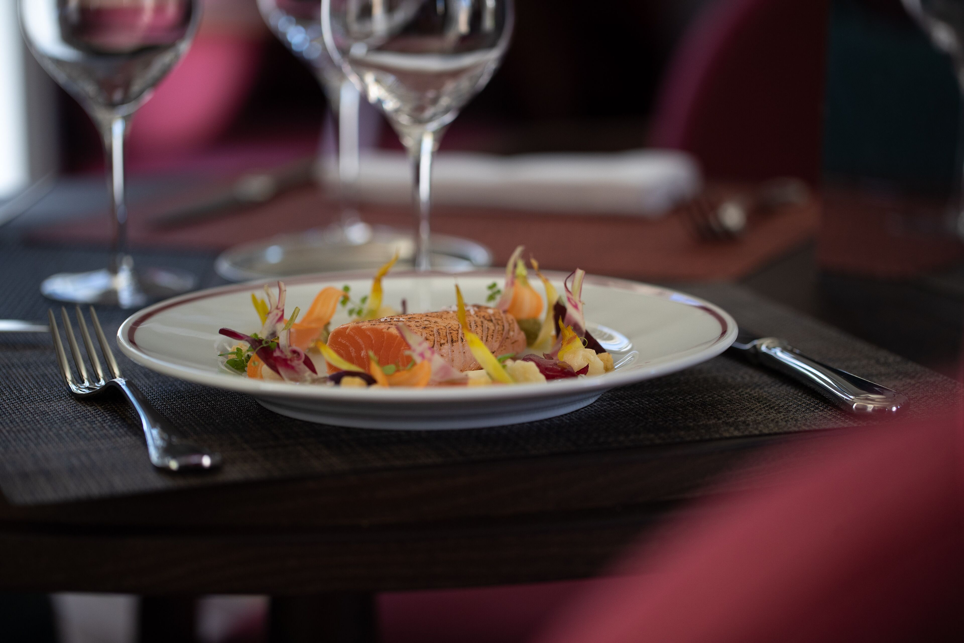 A plate of food on a table with a fork and knife.