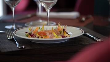 A plate of food on a table with a fork and knife.