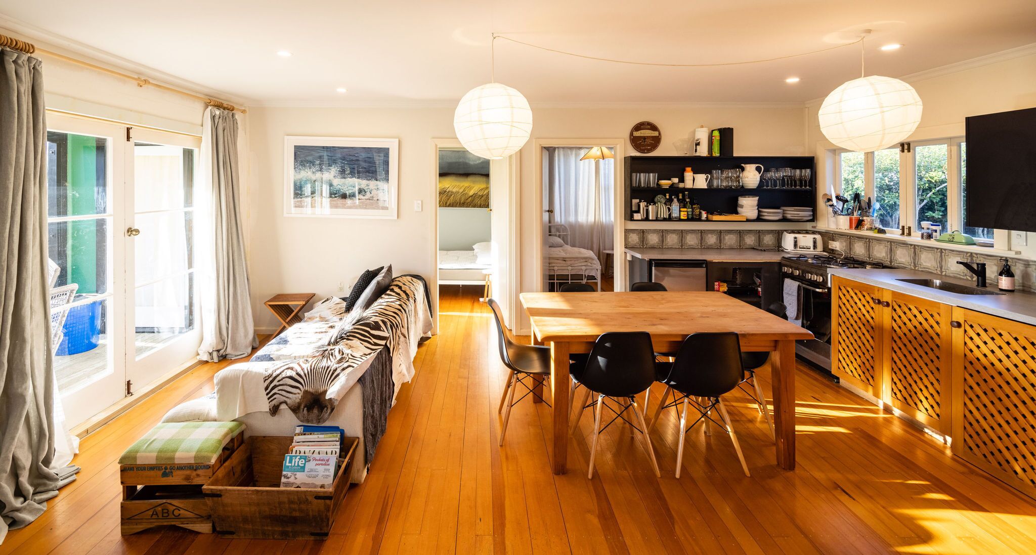 seating in the sun by the french doors, and dining area & kitchen