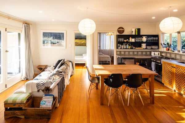 seating in the sun by the french doors, and dining area & kitchen