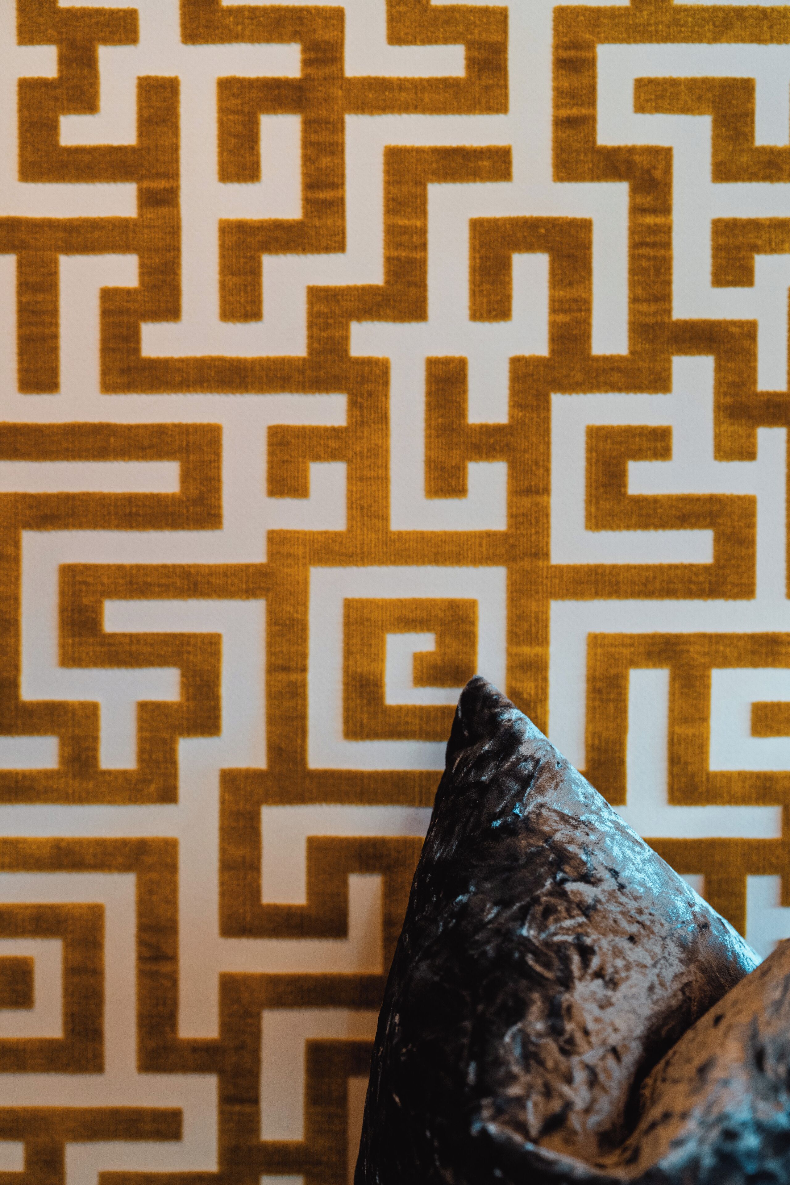 A patterned wall with a geometric design.